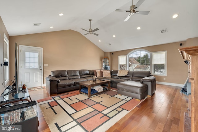 living room featuring hardwood / wood-style flooring, vaulted ceiling, and ceiling fan