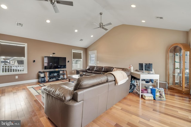 living room featuring ceiling fan, light hardwood / wood-style flooring, and high vaulted ceiling