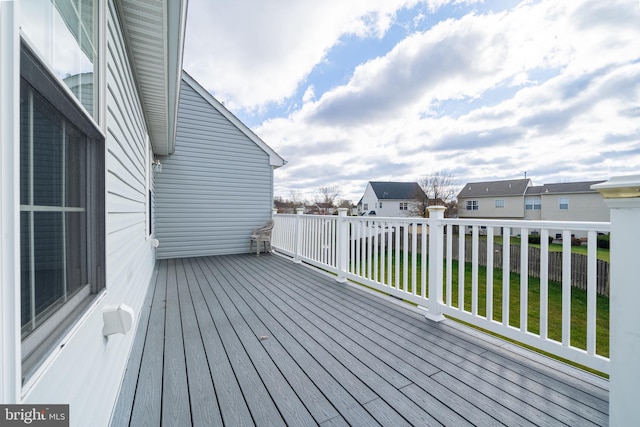 wooden deck featuring a yard