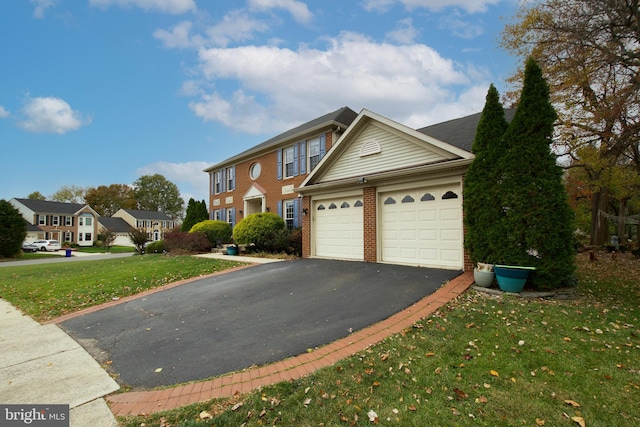 front facade with a front yard and a garage