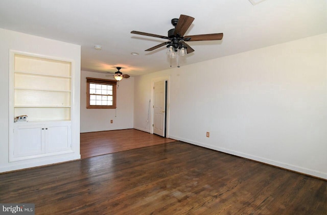 unfurnished room featuring ceiling fan, built in features, and dark wood-type flooring