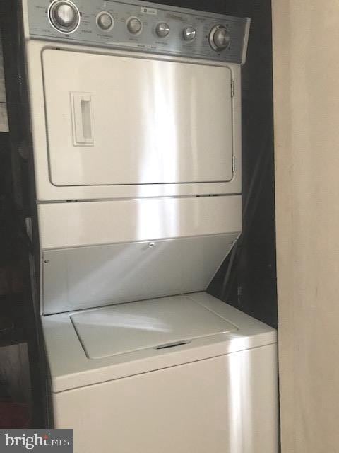 laundry area with stacked washer / dryer