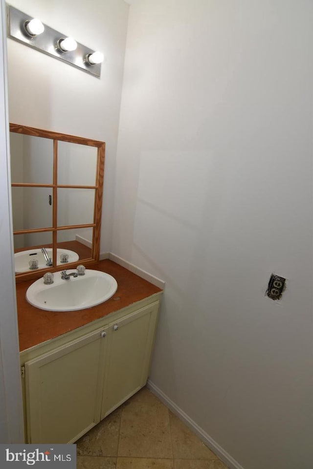 bathroom featuring tile patterned flooring and vanity