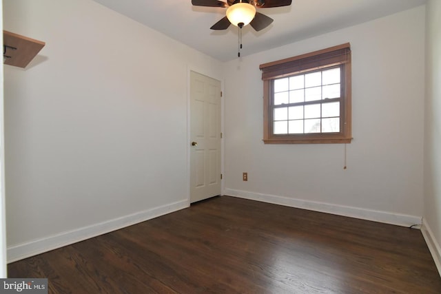 unfurnished room with ceiling fan and dark wood-type flooring