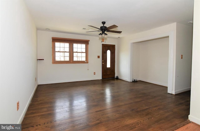 spare room featuring ceiling fan and dark hardwood / wood-style floors