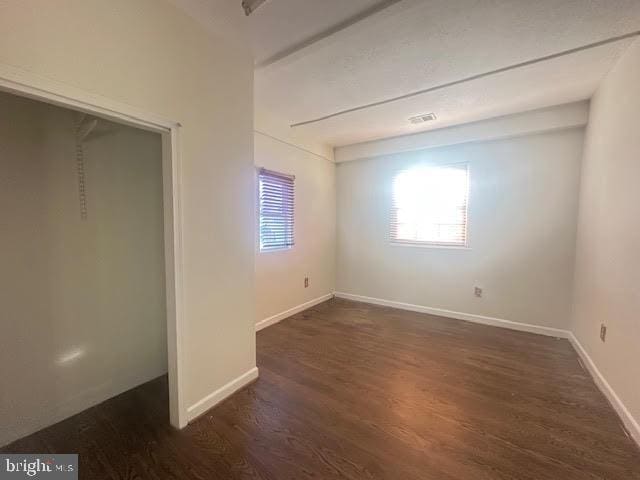 unfurnished bedroom featuring dark hardwood / wood-style floors