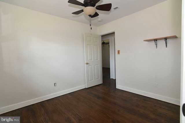 empty room with dark hardwood / wood-style flooring