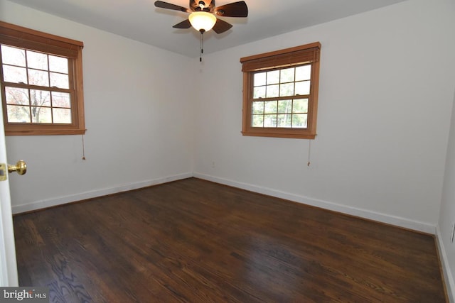 spare room with ceiling fan and dark wood-type flooring