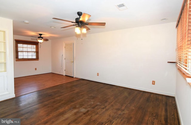 unfurnished room with dark hardwood / wood-style floors