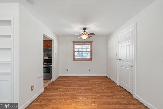 unfurnished dining area featuring ceiling fan and light hardwood / wood-style flooring