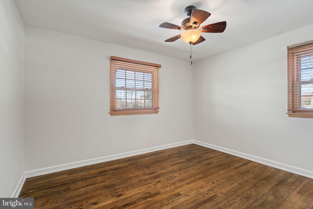 empty room with ceiling fan and dark wood-type flooring