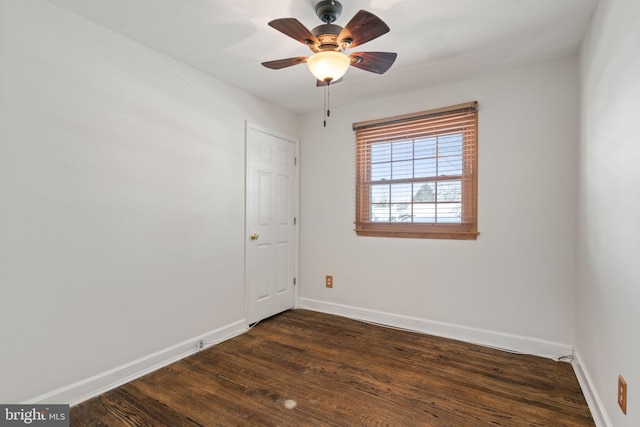 spare room with ceiling fan and dark hardwood / wood-style floors