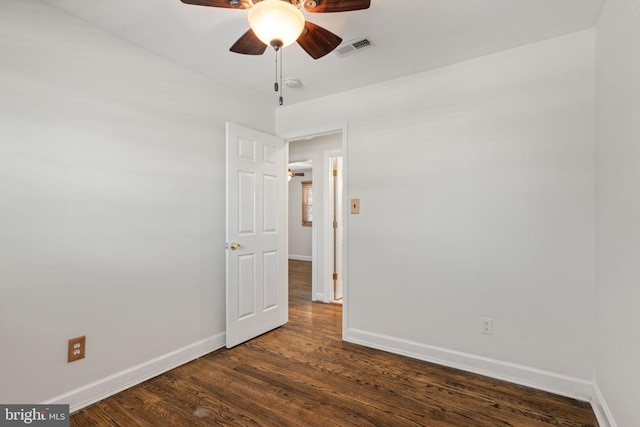 spare room with dark hardwood / wood-style floors and ceiling fan