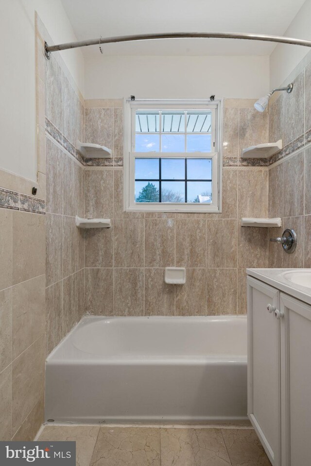 bathroom with vanity and tiled shower / bath combo