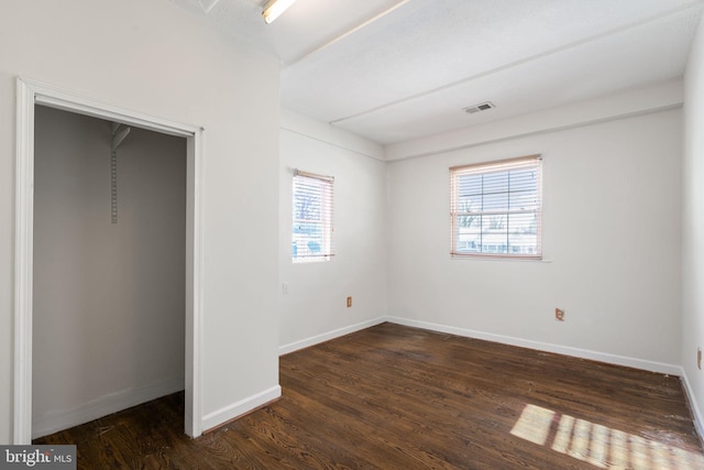 unfurnished bedroom featuring dark hardwood / wood-style flooring