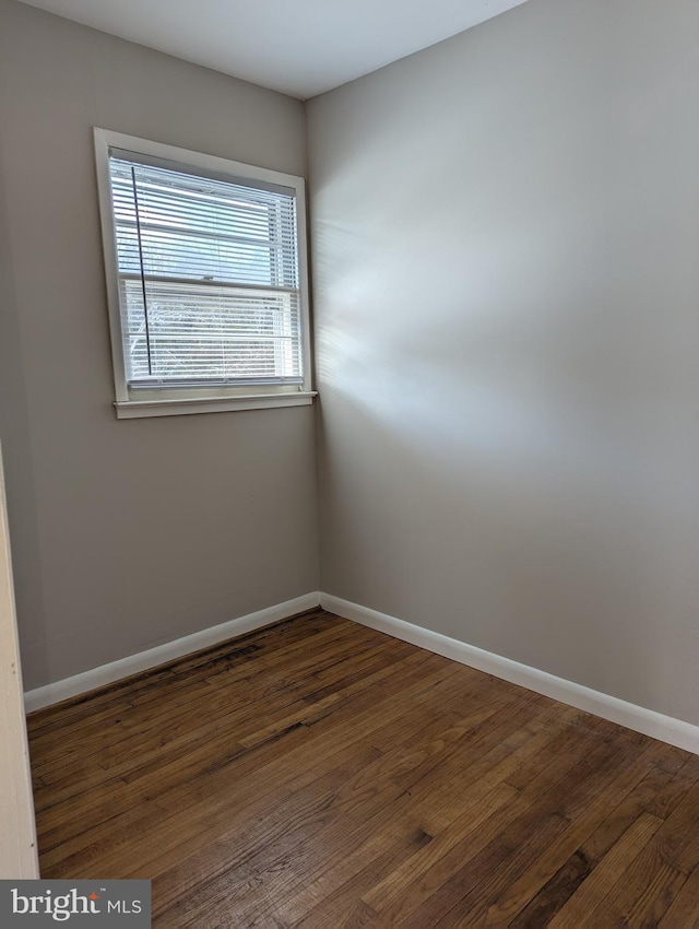 empty room featuring dark wood-type flooring