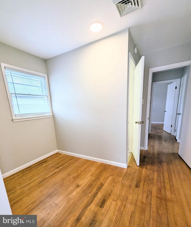 unfurnished room featuring hardwood / wood-style flooring