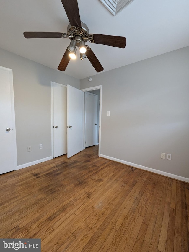 unfurnished bedroom with hardwood / wood-style flooring and ceiling fan