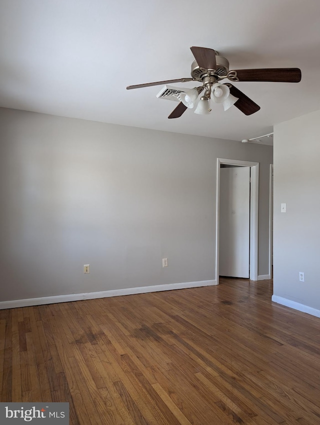 spare room with dark hardwood / wood-style flooring