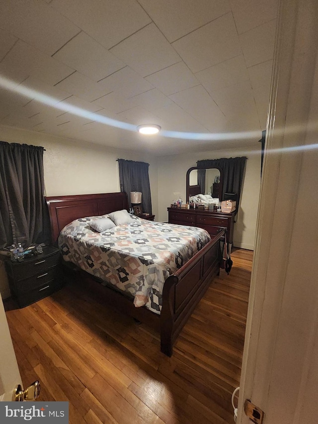 bedroom with dark wood-type flooring