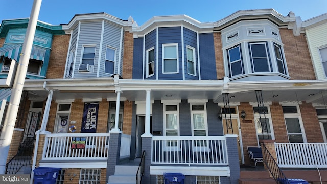 view of property with covered porch and cooling unit