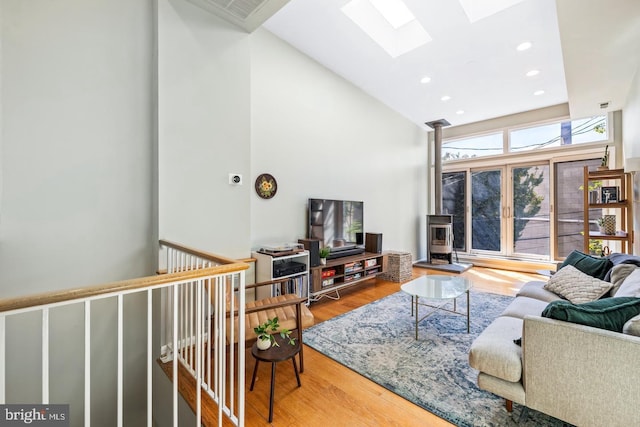 living room with hardwood / wood-style floors and high vaulted ceiling