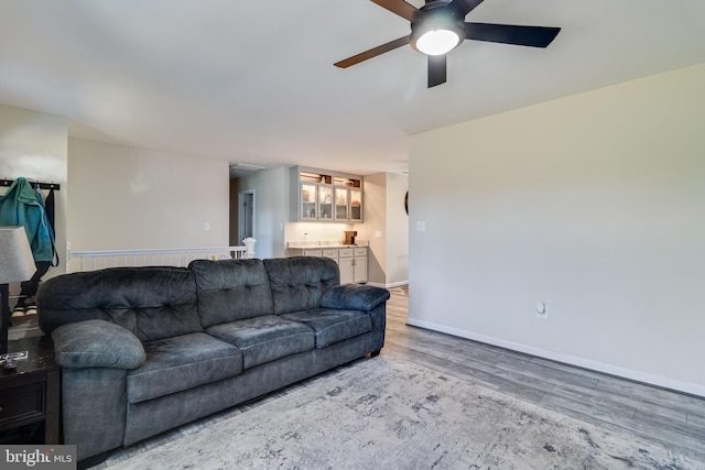 living room with ceiling fan and wood-type flooring