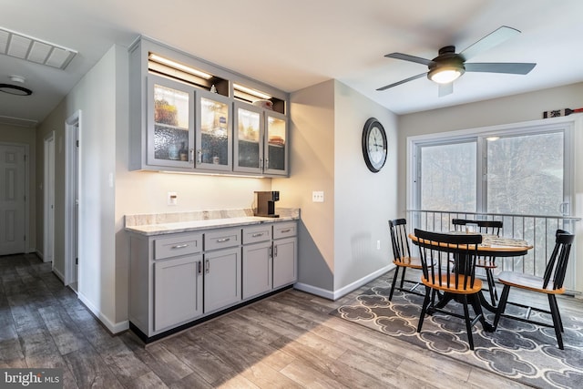 dining area featuring wood-type flooring and ceiling fan