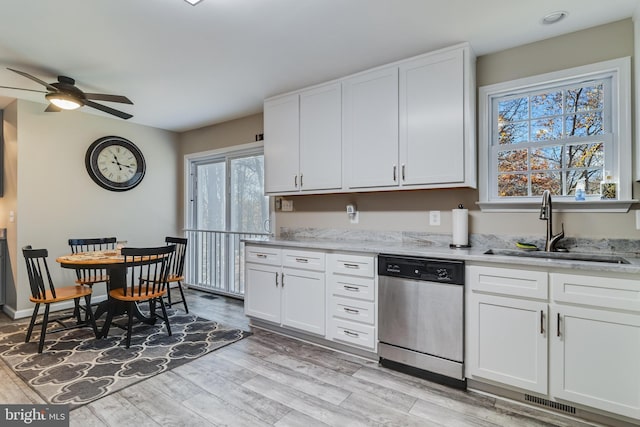 kitchen with white cabinets, dishwasher, light hardwood / wood-style floors, and sink