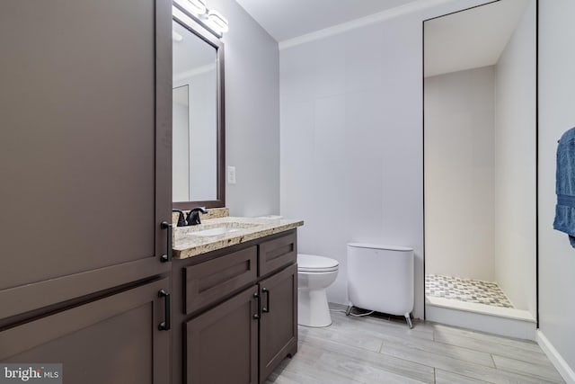 bathroom featuring vanity, toilet, wood-type flooring, and a shower