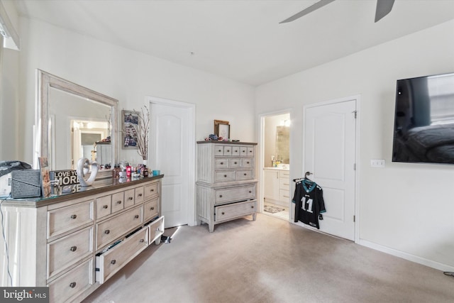 carpeted bedroom featuring ceiling fan and ensuite bathroom