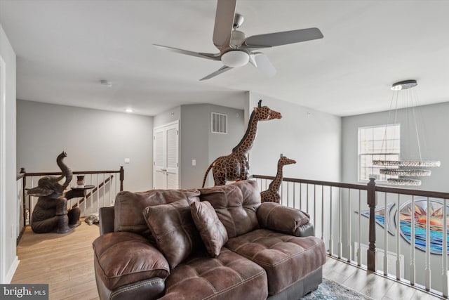 living room with ceiling fan and light hardwood / wood-style floors