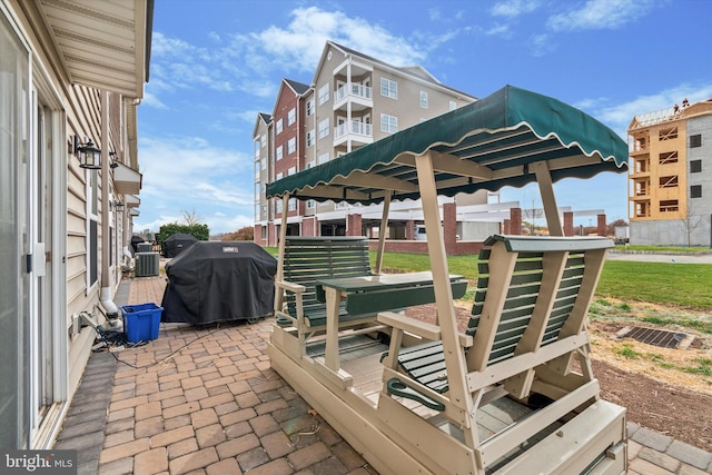 view of patio / terrace featuring cooling unit and a grill