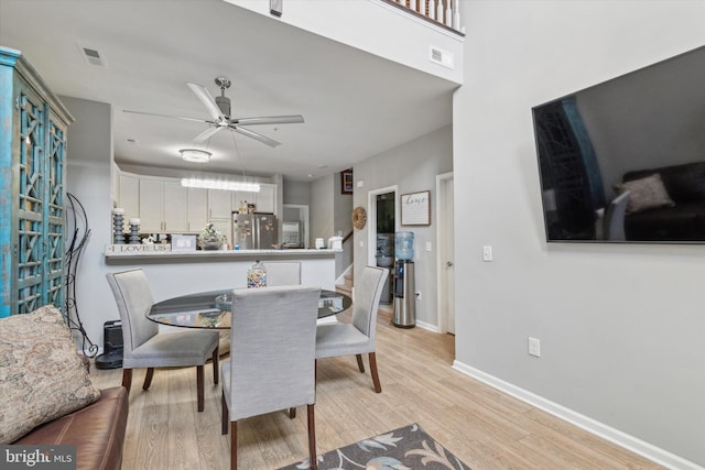 dining room featuring ceiling fan and light hardwood / wood-style flooring