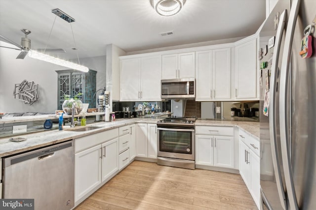 kitchen featuring white cabinetry and appliances with stainless steel finishes