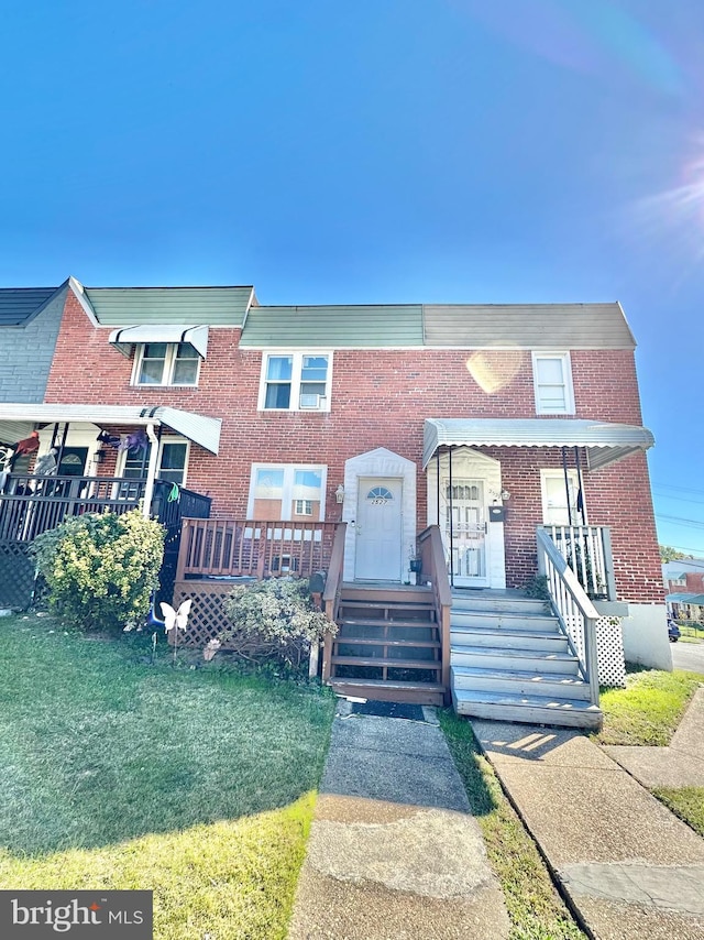 view of property with a porch and a front lawn