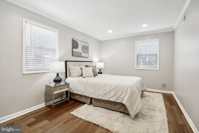 bedroom featuring dark hardwood / wood-style flooring and ornamental molding