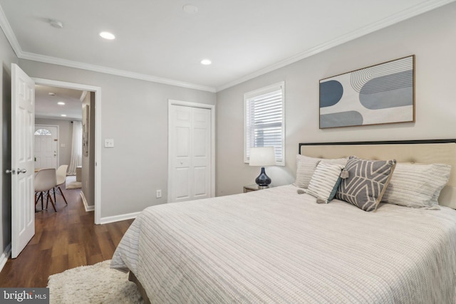 bedroom with crown molding, dark wood-type flooring, and a closet