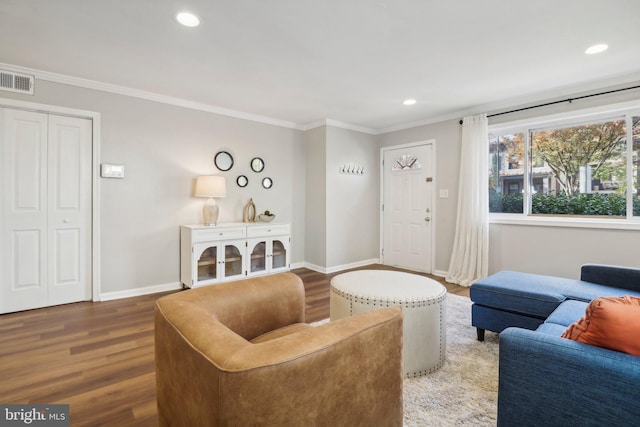 living room featuring crown molding and hardwood / wood-style flooring