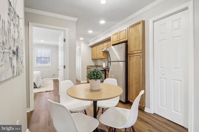 dining room featuring dark hardwood / wood-style flooring and crown molding