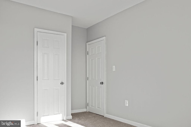 unfurnished bedroom featuring light colored carpet