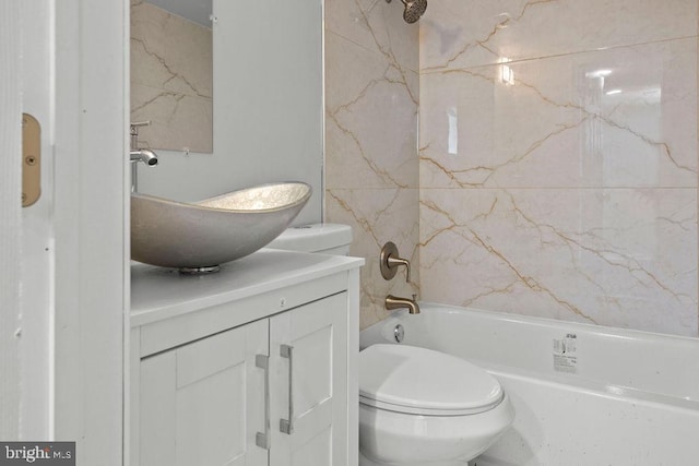 full bathroom featuring washtub / shower combination, vanity, and toilet