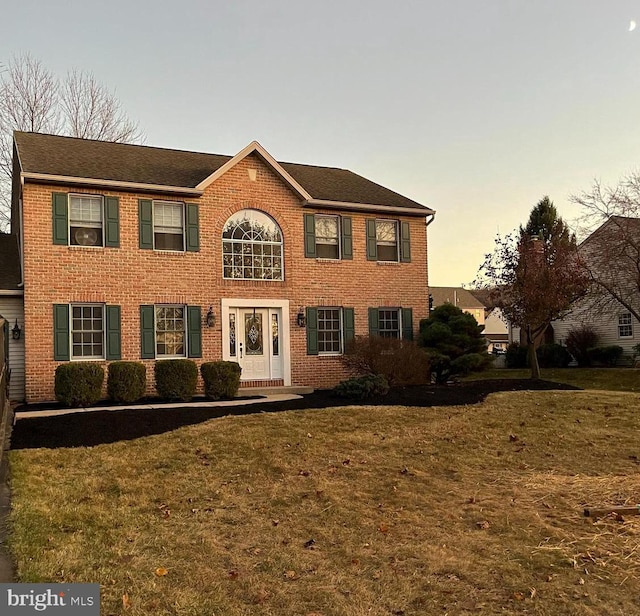 colonial-style house with a yard