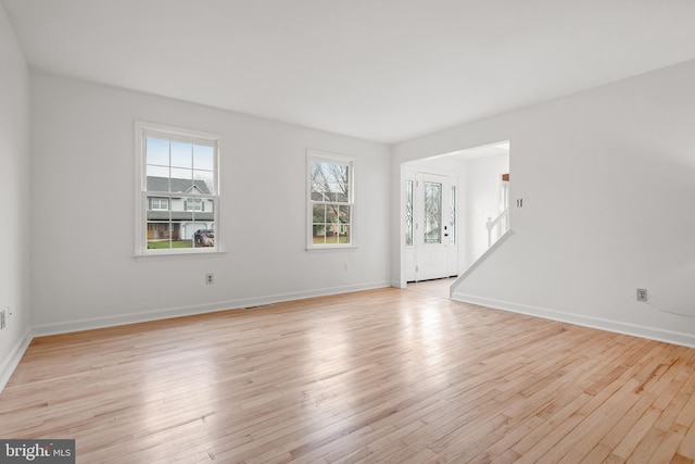 empty room with light hardwood / wood-style floors