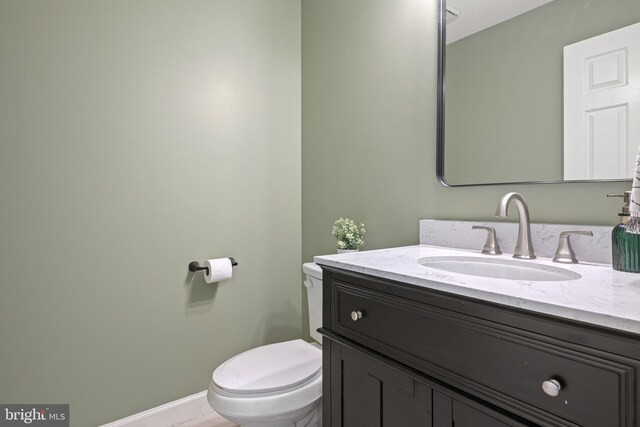 bathroom with tile patterned flooring, vanity, and toilet