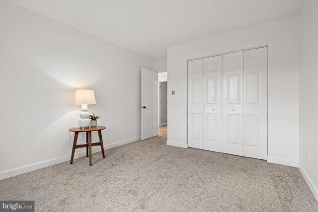 unfurnished bedroom with carpet floors and a closet