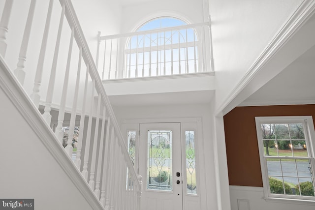 foyer entrance featuring ornamental molding