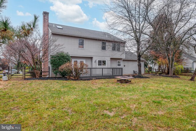 back of property featuring a yard and a deck