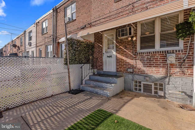 property entrance featuring a patio area and cooling unit