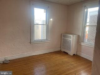 unfurnished room with light hardwood / wood-style floors